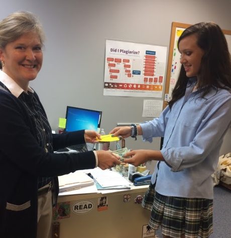 Beta Club president Bailey Toole sells spaghetti supper tickets to English teacher Dr. Ann Dromsky on Tuesday morning.