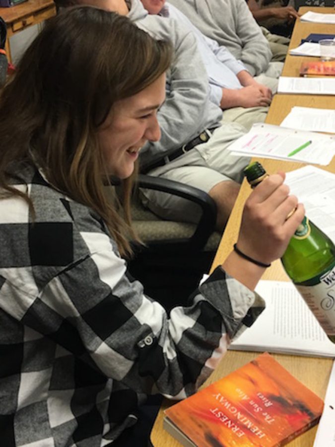 Junior Ellie Wangerin is all smiles as she takes a sip of her sparkling grape juice