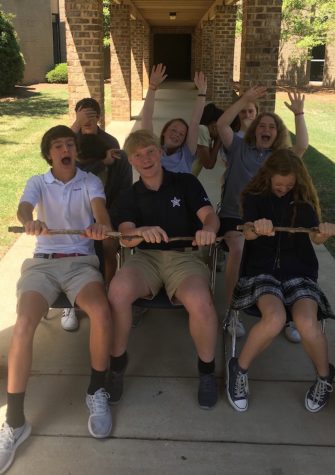 Members of the Gazebo Middle School staff re-enact a roller coaster ride on the walkway at the front of campus