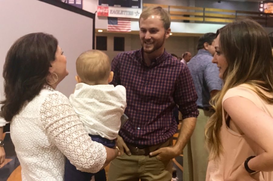 Henley visits with librarian Susan Marshall and her family