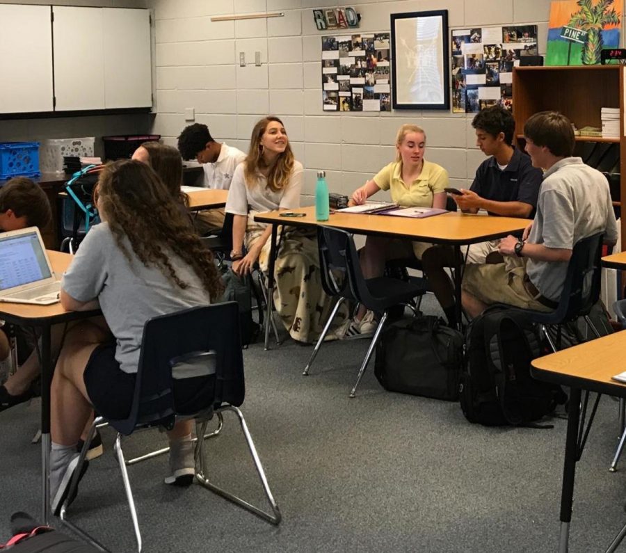 Students talk before class in Dr. Ann Dromskys sixth period Senior English