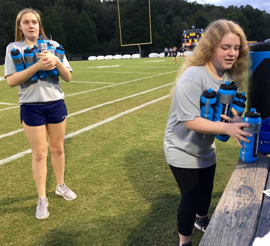 Miller Cranford, left, and EmmaJane Canady stay busy on the sidelines on Friday nights
