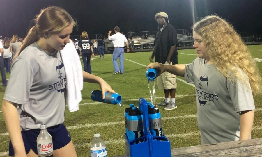 Miller Cranford and EmmaJane Canady have to keep the water flowing during the game