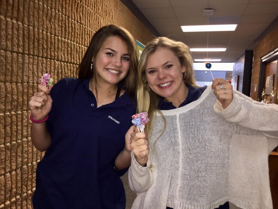 Hadley Neal, left, and Caroline Cole were among the varsity cheerleaders who had treats for Stratford students on Tuesday 