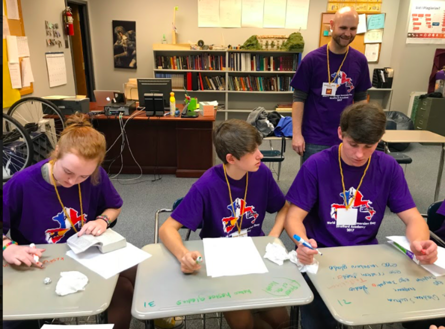 Upper School Latin teacher Mr. Brian Wells supervises an activity for Riley Davis, George Seagraves and Harrison Tuck