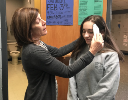 Assistant Principal Mrs. Theresa Ferrari tends to sophomore Maya Rubenstein