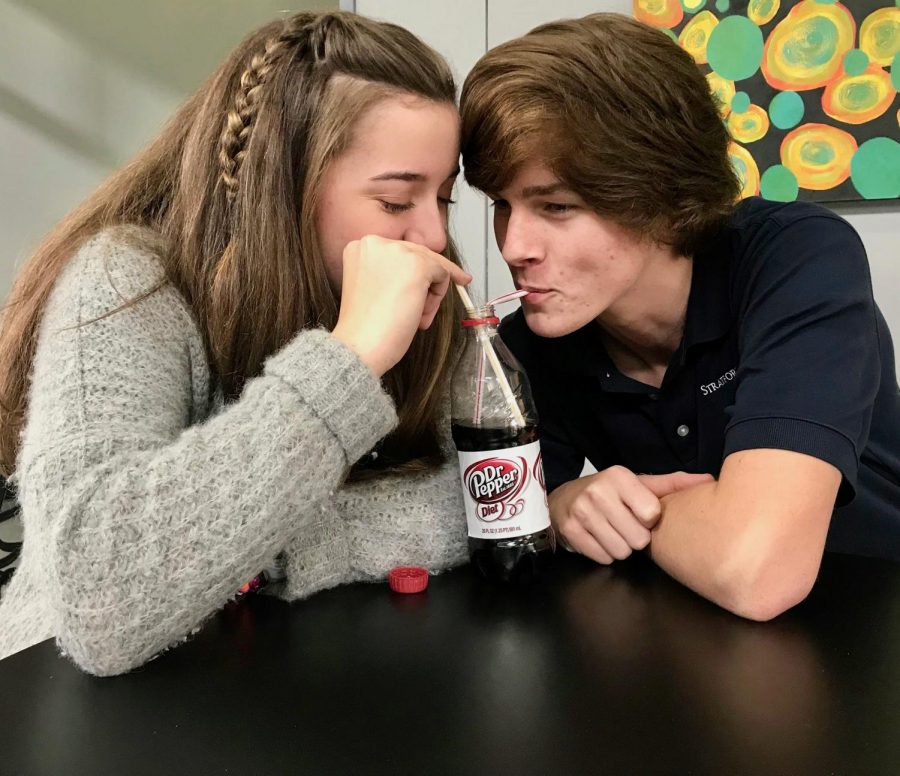 Abby Ellison and Carter Barfield share a Diet Dr. Pepper in the lobby of the science building