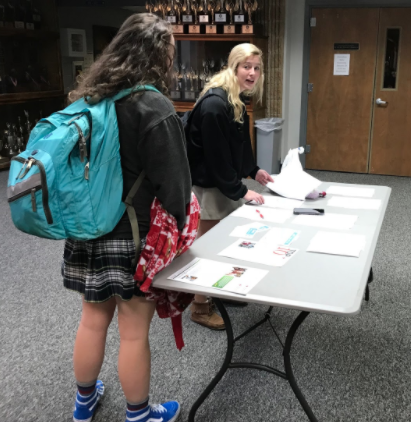 Senior Tori Dover, right, signs up for Friday's Blood Drive in the front lobby while talking to junior Gracie Bell