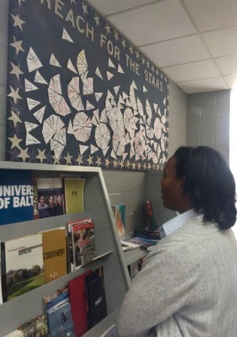 Junior Reese Ellis checks out the recent college acceptances on the bulletin board