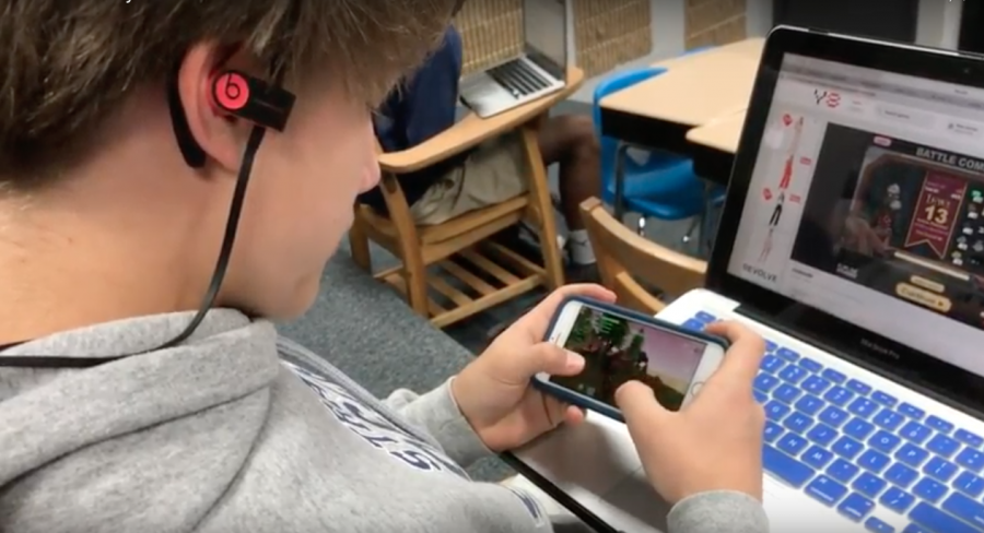 Freshman Jay Lee plays Fortnite on both his phone and laptop computer