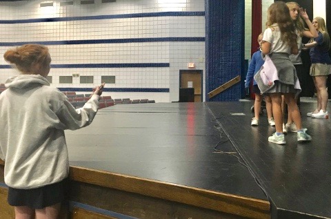 Sophomore Riley Davis instructs Lower School students in "Charlotte's Web" at a recent rehearsal