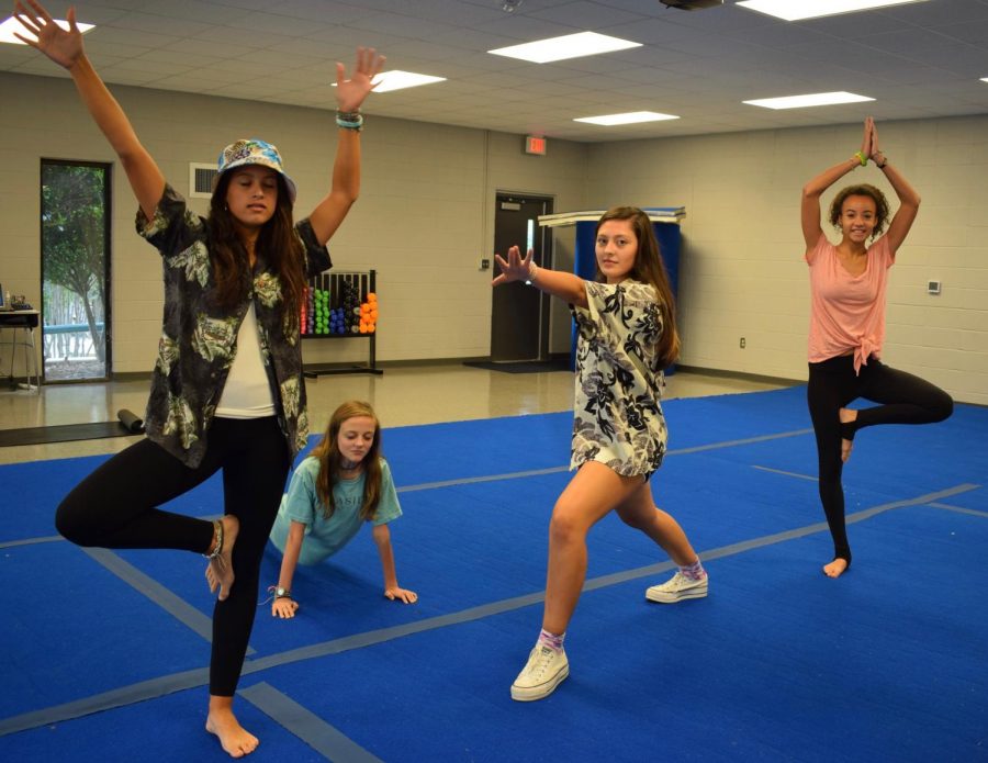 Taylor Justice, Madelyn Poss, Marlie Potts, Annika Brooks participate in 5th period yoga.
