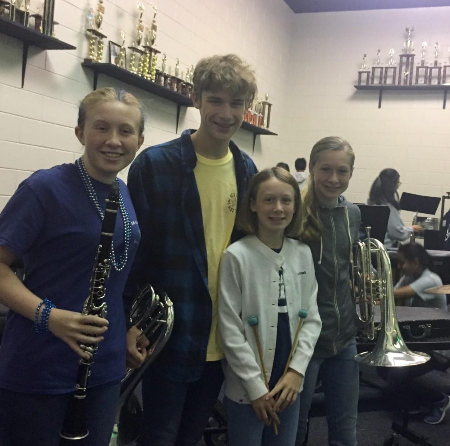 (L-R) Nora, Benjamin, Ginny, and Gracie Jorgensen pose in the band room.