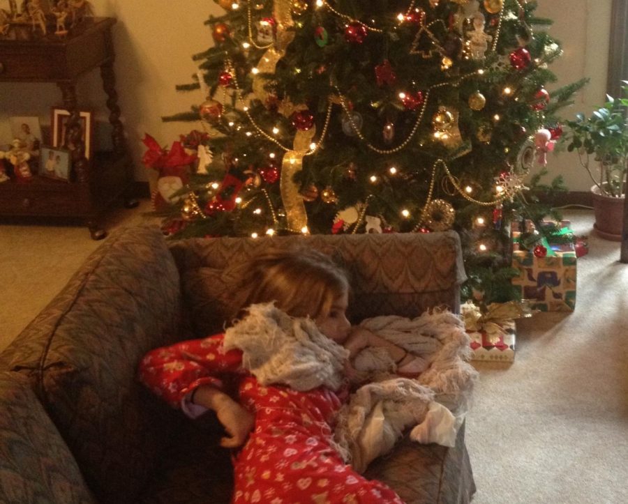 Camilla Veale as a child waiting by the Christmas tree