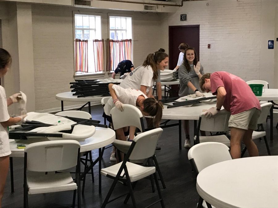 Mary Kate Groves, Emily Hunt, Akins Manley, and Mary Blue Butler clean tables at the Macon Outreach. 