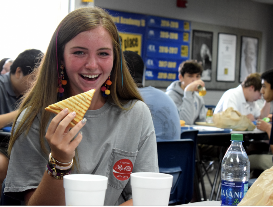 Langley Anne Faulkner proudly wears her spirit shirt as she enjoys pizza in the cafeteria during lunch