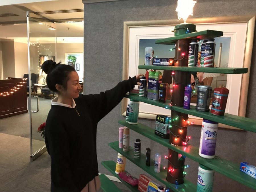 Jocelyn Tang admires Christmas tree that design class created. 