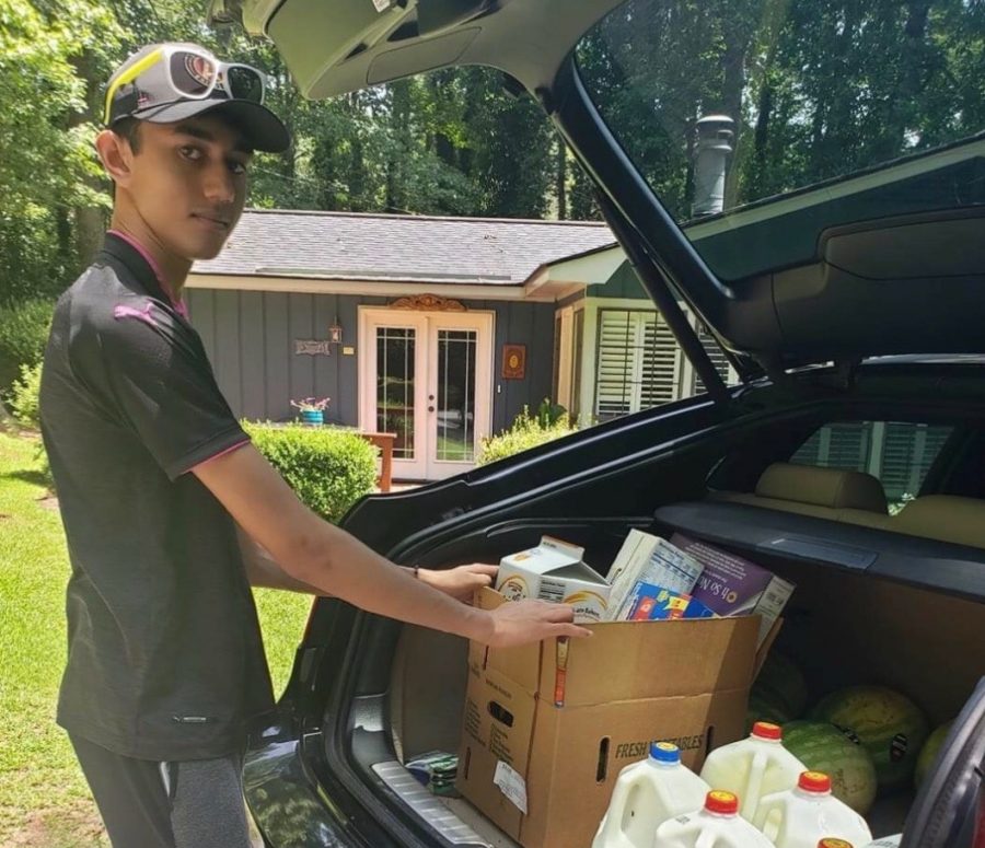 Haaris Ahmed loads food in his car to distribute to families in need