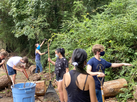 Upper School students remove debris from Macon Little Theatre parking lot.