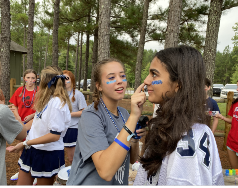 Molly Edward Seagraves, left, and Mia Bhafin enjoy face painting at freshman retreat